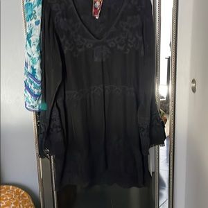 Black dress or top with lace cuffs and lace inset.
